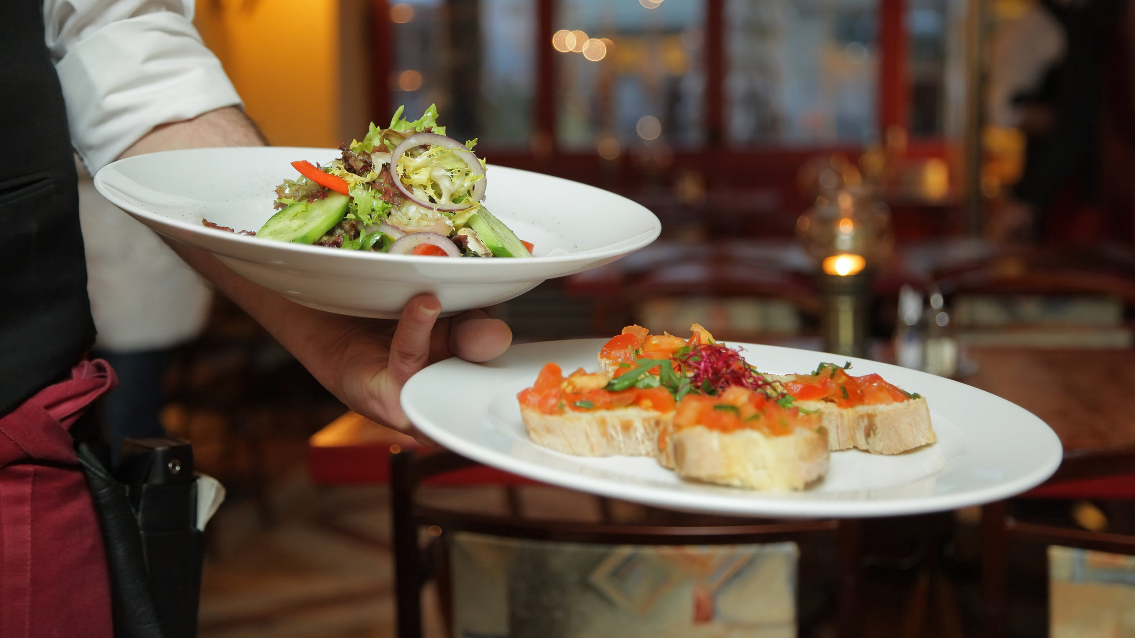 Bord with four delicious appetizers, which are served at a table at the Cantarel