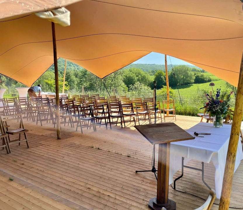 Open air tent at Modern with plenty of seats for a speech gathering