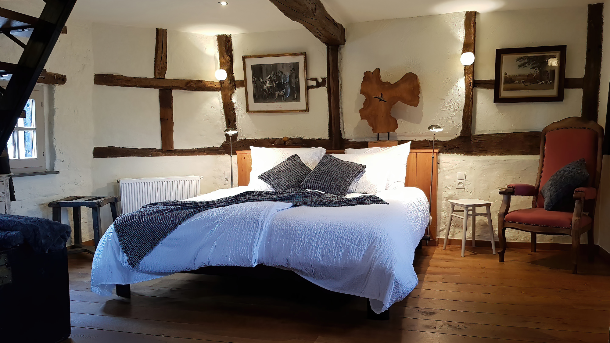 Luxurious bedroom with beam construction in an old farmhouse.