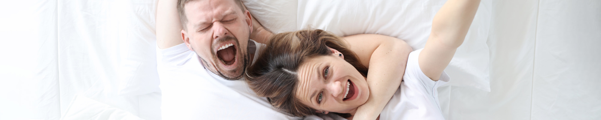 Man and woman lie together in a wonderful hotel bed